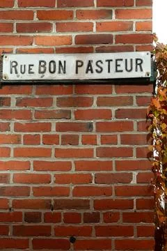 Vertical view of Bon Pasteur street sign Stock Photos