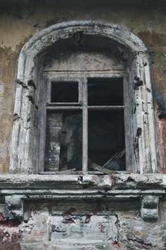 Vertical view of broken scary window of abandoned house Stock Photos