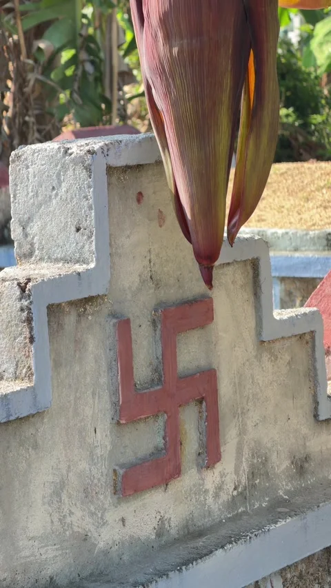 Vertical view of a Buddhist grave with a red swastika symbol standing among Stock Footage 332124758