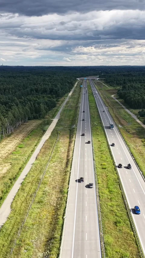 Vertical view. Busy motorway carrying freight and passenger traffic Video stock 348630853