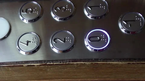 Vertical view of buttons of an old elevator as the lift goes down to the Stock Footage 254017258