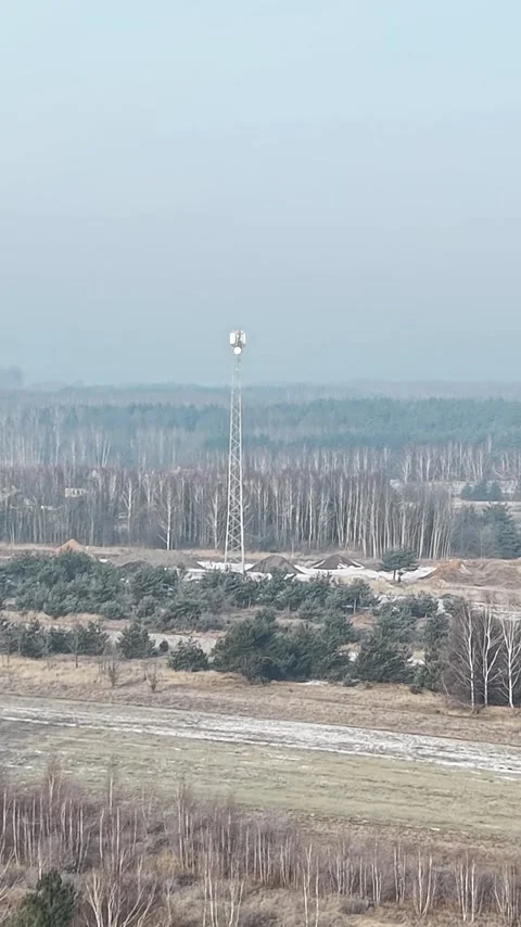 Vertical view. Cellular internet transmission tower under cloudy sky aerial view Stock-Footage 348630966