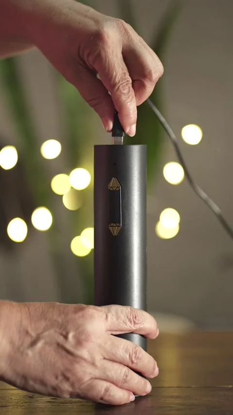 Vertical view of charging method on an electric wine opener with USB cable at Stock Footage 327339532