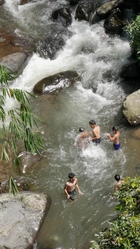 Vertical view of children playing in rural river water. Stock Footage 336322171