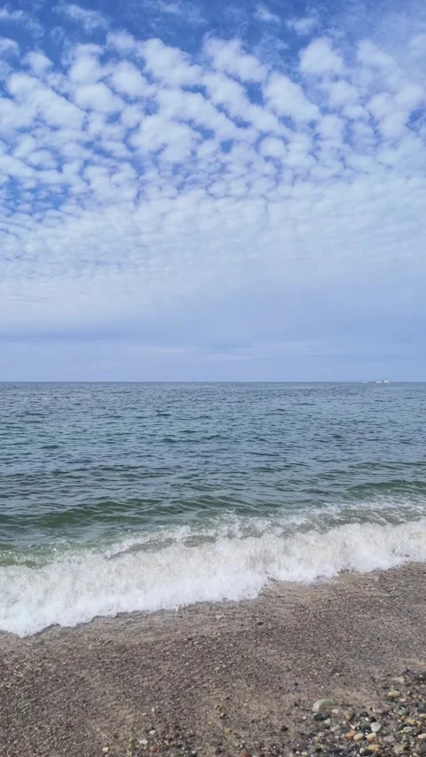 Vertical View of Cirrocumulus Clouds and Calm Sea Stock Footage 346557942