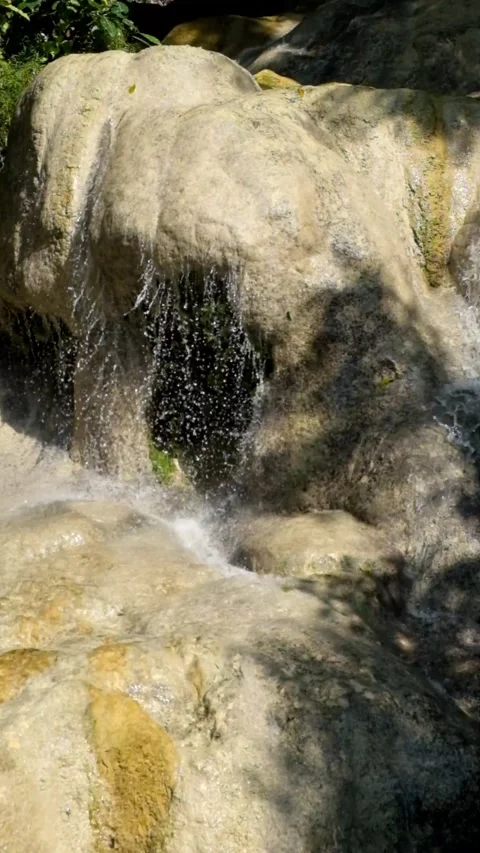A vertical view of a clear waterfall on a limestone mountain. Stock Footage 321321233