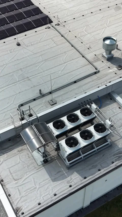 Vertical view. Commercial building flat roof with condensers Stock Footage 348630897