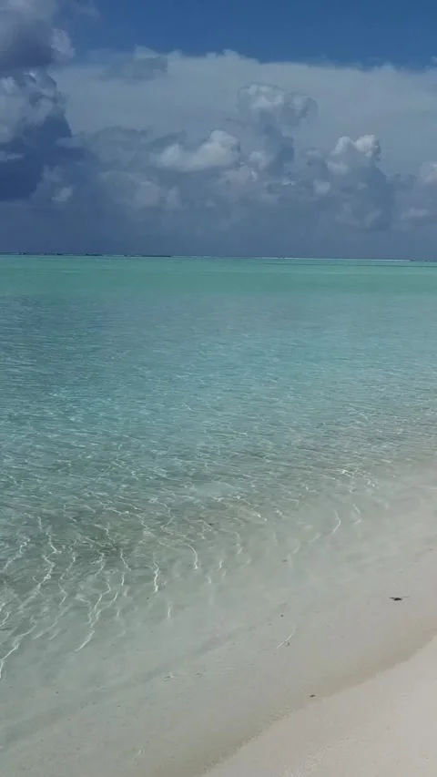 Vertical view of crystal clear ocean water on white sand beach in Faafu Atoll Stock Footage 344257132