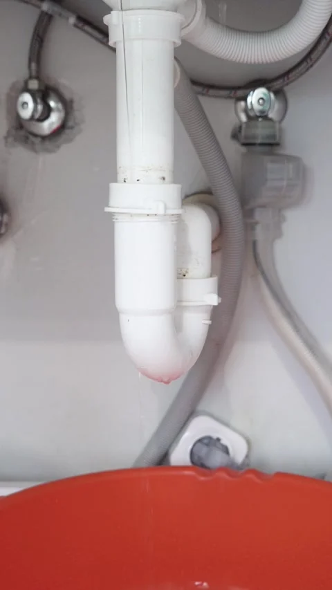 Vertical View of Damaged Kitchen Sink Siphon Leaking Water Stock Footage 311501701