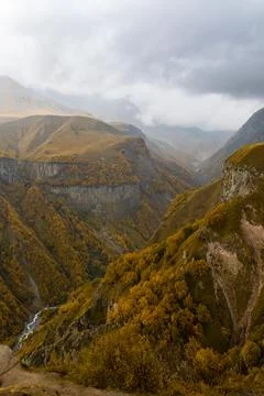 Vertical View Of Deep Mountain Gorge With River And Autumn Forest Stock Photos