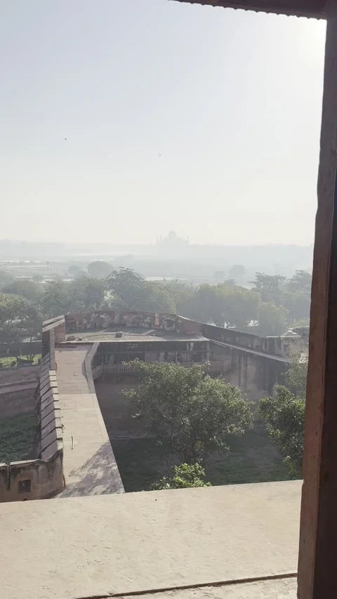 Vertical view of distant Taj Mahal through Agra Fort window in Agra India 스톡 동영상 343134232