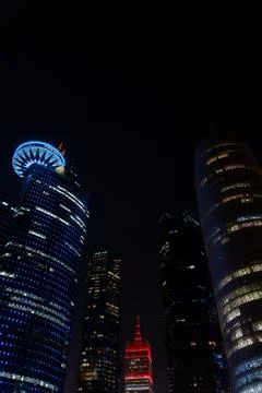 Vertical view of Doha skyline at night featuring Burj Doha, WTC Doha Stock-Fotos