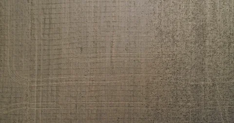 Vertical view down on freshly ploughed farm land field with tractor tracks cr Stock Footage 104064295