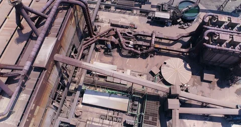 Vertical view down on sprawling industrial complex with rusty pipes Stock Footage 85957811
