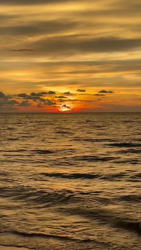 Vertical View Of Dramatic Golden Sunset Over Sea Ripple Waves Stock Footage 335344657