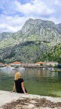 Vertical view of dramatic mountains rising above coastal town in Kotor Foto stock