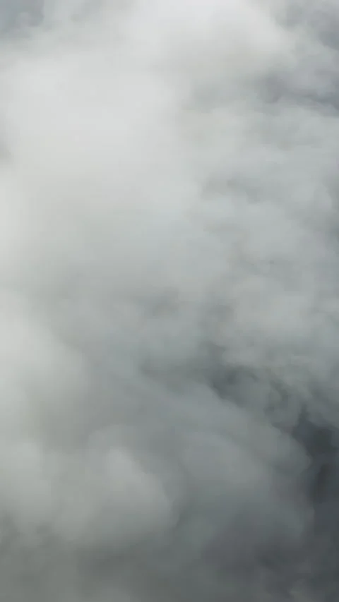 Vertical View Drone Flying Through White Fog and Dramatic Sky Clouds Above the Stock Footage 347400063