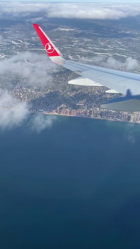Vertical View of Earth and Clouds from Descending Airplane Stock Footage 297295104
