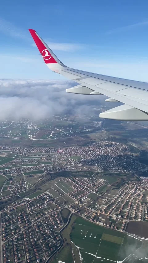Vertical View of Earth and Clouds from Descending Airplane Stock Footage 297295345