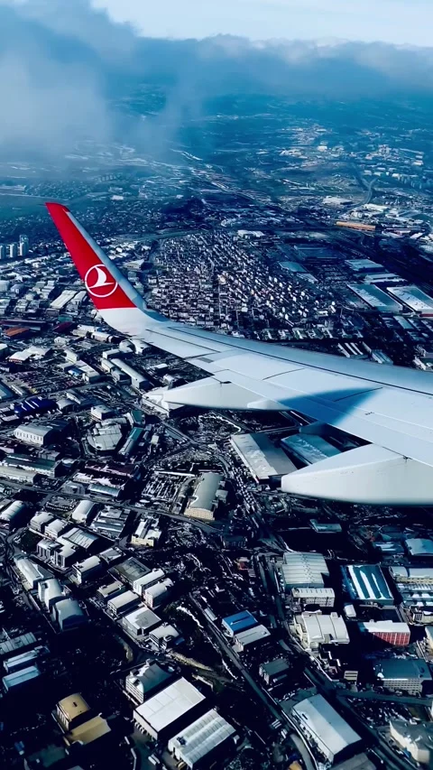 Vertical View of Earth and Clouds from Descending Airplane Stock Footage 297316612
