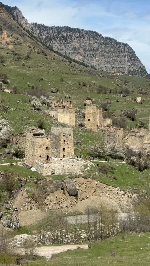 Vertical view of the Egikal tower complex surrounded by rocky slopes and Video stock 335076827
