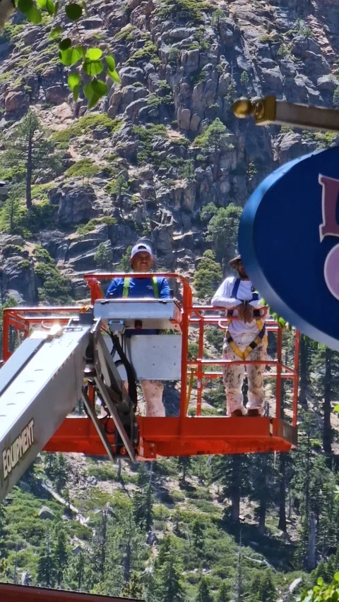 Vertical View of Electricians on Aerial Work Platform Going Up by Building Video stock 315504158