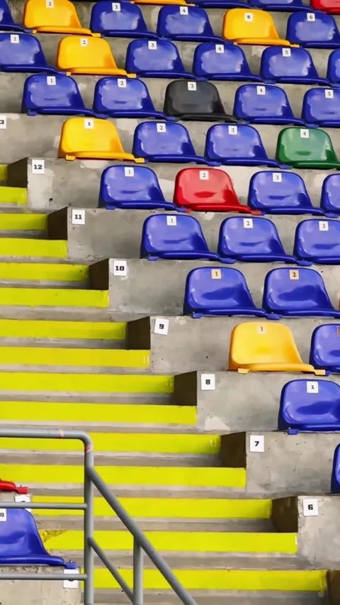 Vertical view of empty stadium stands with bright yellow stairs, numbered Stock Footage 340920235