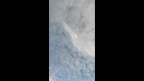 Vertical View of Fluffy Altocumulus Clouds Covering Blue Sky Stock Footage 343891923