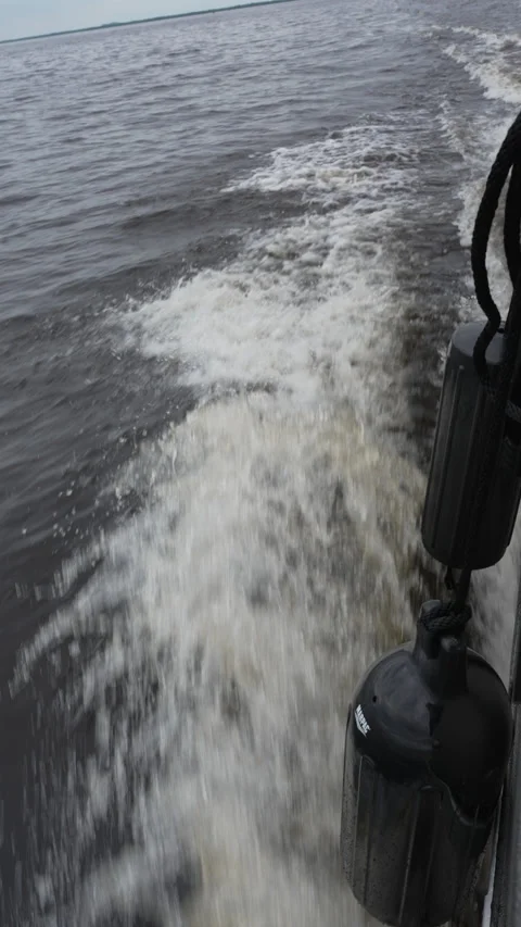 Vertical view of foamy boat wake on lake Stock Footage 344828810