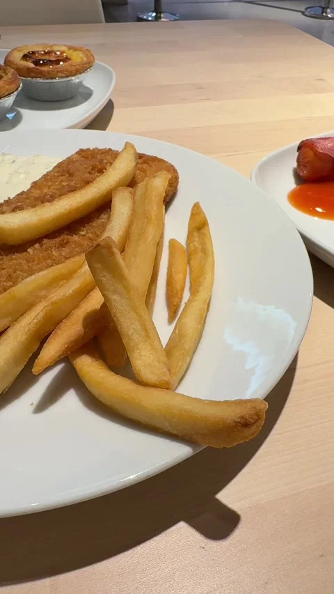 Vertical View Of Fork Picking Up French Fries From Fish Steak Meal Plate Stock Footage 346596666