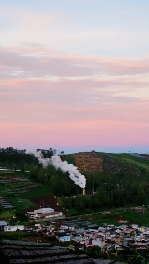 Vertical view of geothermal power plant steam in the mountains in the mornin Stock Footage 320978231