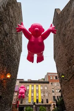 Vertical view of giant inflatable Mr Pink sculptures by Philippe Katerine Stock Photos