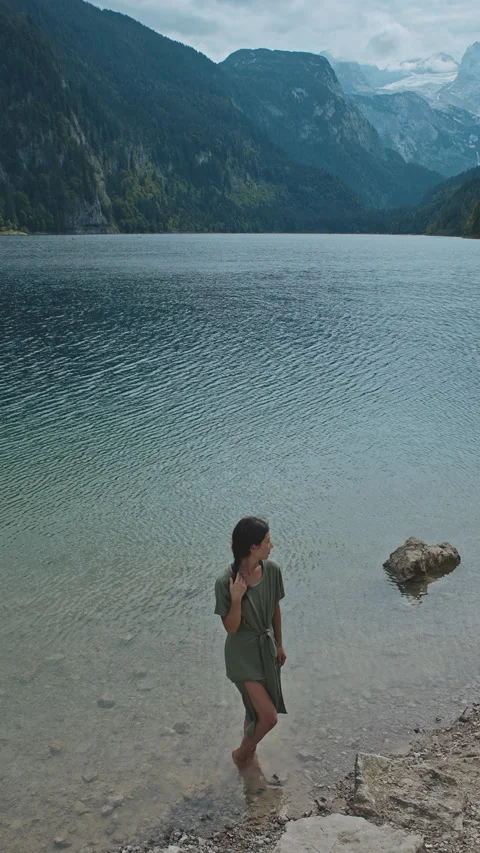 Vertical view of girl feeling one with nature in mountains and lakes of Austria Stock Footage 145010264