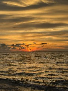 Vertical View Of Golden Sunset Over Sea From Batu Ferringhi Beach Stock Photos