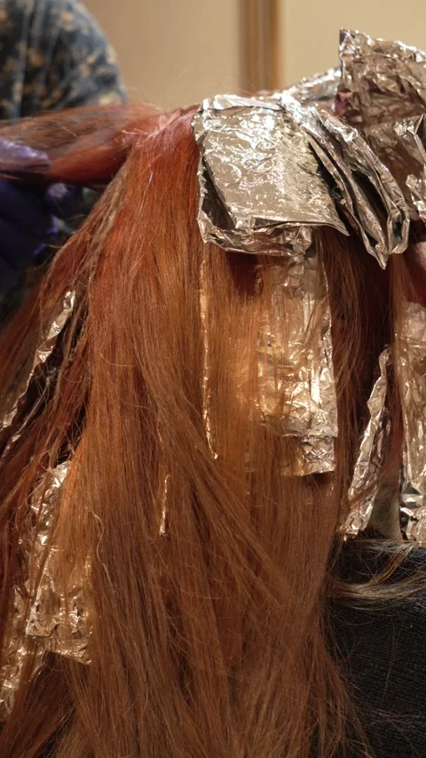 Vertical View of Hair Coloring Process Using Silver Foil Stock Footage 318769345