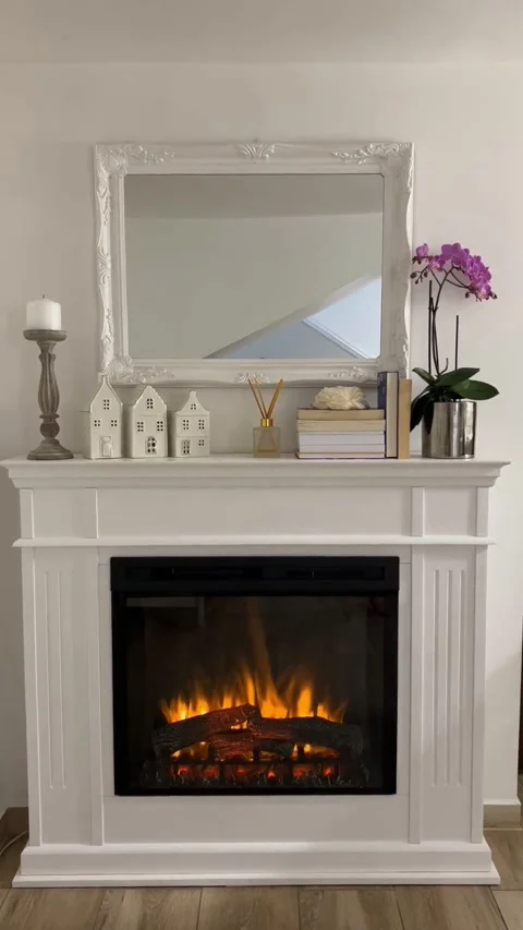 Vertical view of handmade wood fireplace mantel with glowing electric fire Видео 343158505