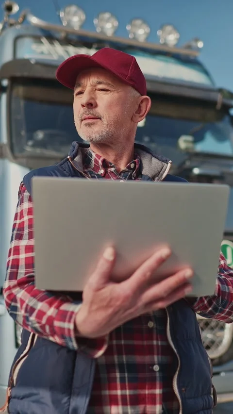 Vertical view of handsome Caucasian man in red cap holding open laptop while Stock Footage 306580981