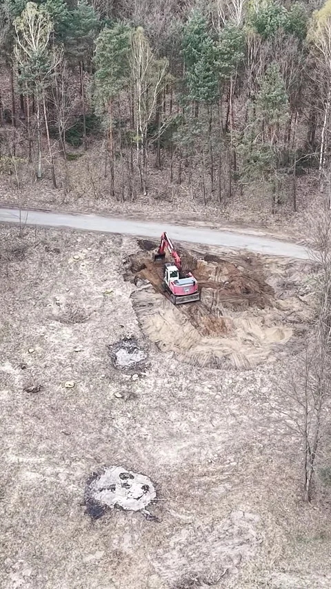 Vertical view. Heavy duty machine digging and moving soil outdoors Stock-Footage 348630781