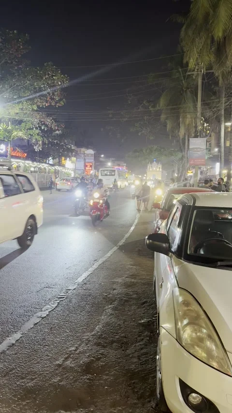 Vertical view of heavy night traffic and illuminated street in Calangute Goa Stockbeeldmateriaal 343131721