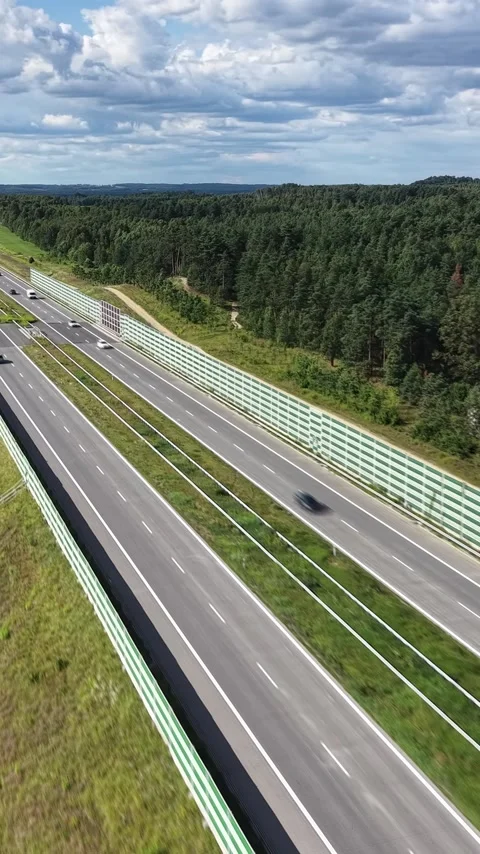 Vertical view. High angle view of fast traffic motion on countryside freeway Video stock 348630833