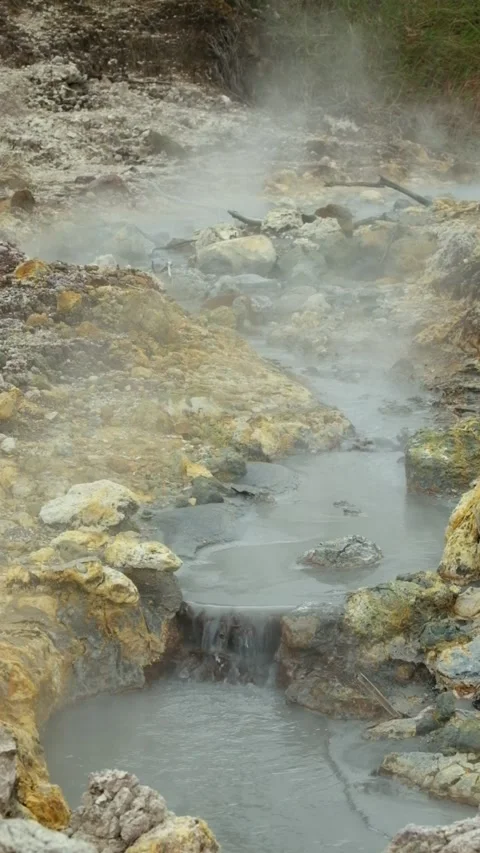 Vertical view of hot mud flow and steam in the active crater area Stock Footage 319907237
