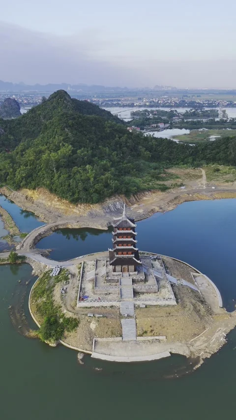 Vertical view of isolated temple on water at Bai Dinh Pagoda, Ninh Binh – 4K Stock Footage 325040564