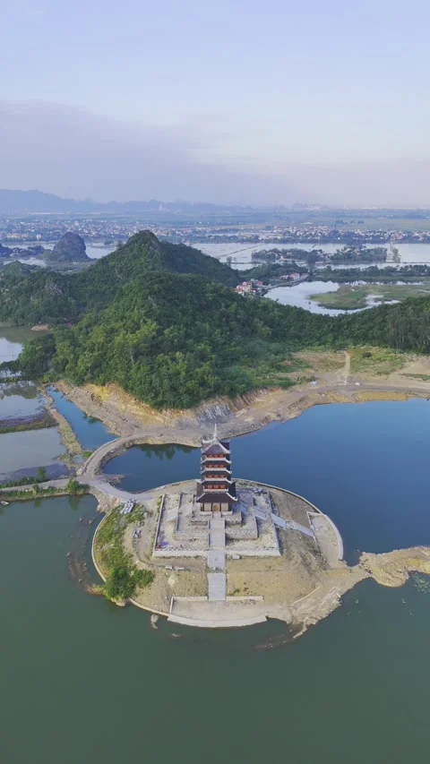 Vertical view of isolated temple on water at Bai Dinh Pagoda, Ninh Binh – 4K Stock Footage 325040566