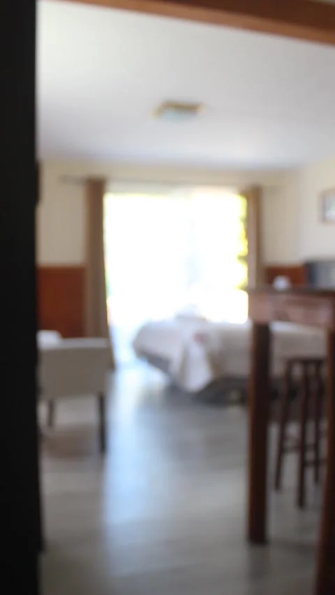 Vertical view of a key hanging on a hotel door with a background of a bedroom Stock Footage 239026107