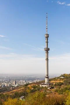 Vertical view from the Kok Tobe mountain with a TV tower to the city of Almaty Stock Photos