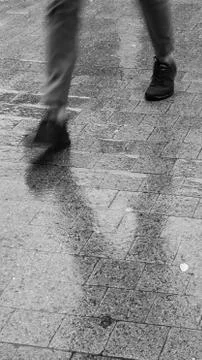 Vertical view of legs walking during rain Stock Photos