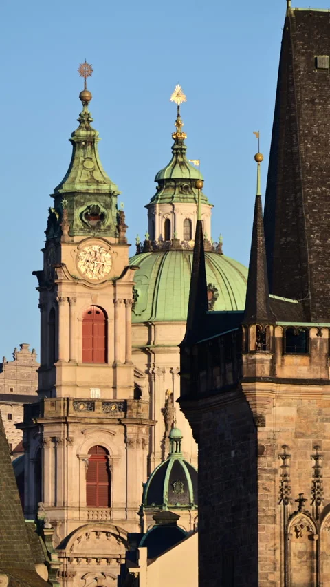 Vertical view of the Lesser Town Bridge Tower beside the clock tower and green Video stock 342252542