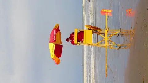 Vertical view of lifeguards looking around towards the sea. Stock Footage 241975321