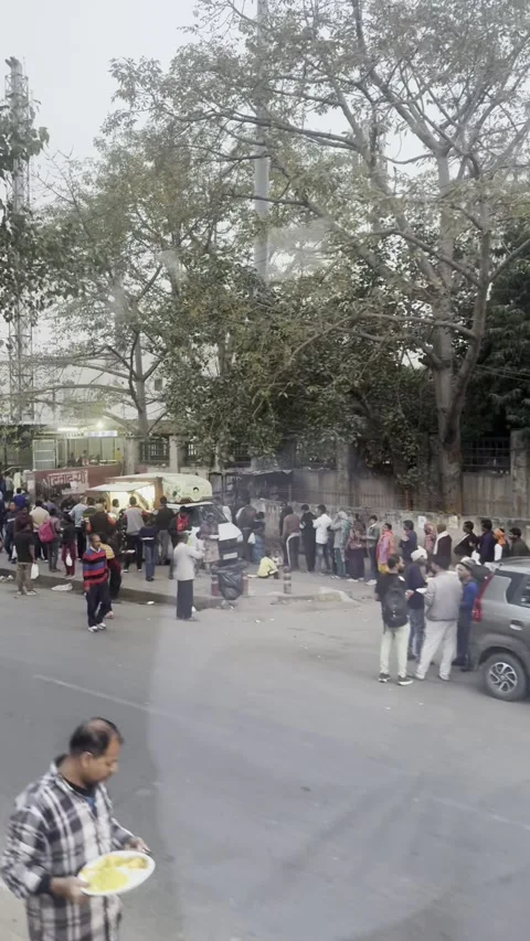 Vertical view of long queue for free food distribution on New Delhi street India Vídeo Stock 343133357