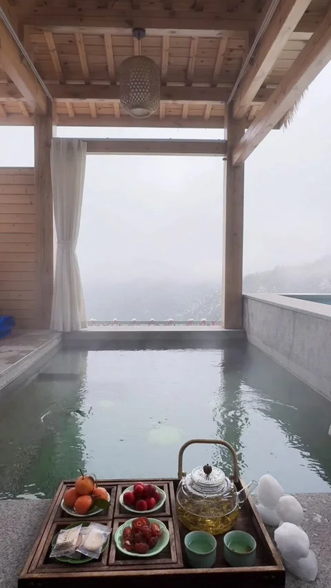 Vertical View of Luxury Private Hot Spring with Snow Mountain View Stock Footage 328063267